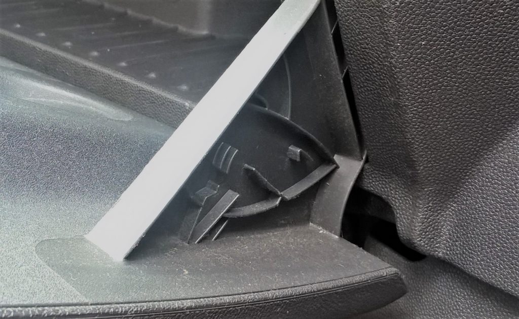A shape of a shark on the glovebox hinge in a Vauxhall Corsa D, a hidden easter egg