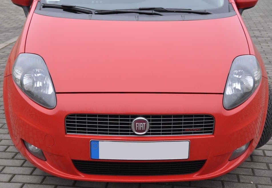 Used, red Fiat car in great condition - even panel gaps and clear headlights. No colour mismatch between body panels.