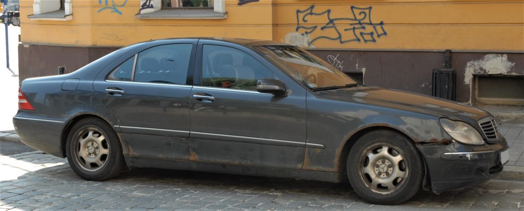 Grey, Corroded Mercedes-Benz W220 S-Class car. A pre-facelift model with rust visible on every body panel.
