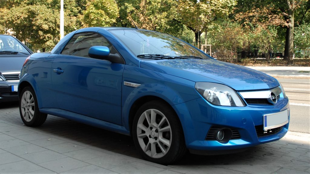 Used, blue Opel Tigra TwinTop on OEM alloy wheels, hardtop convertible with the roof closed