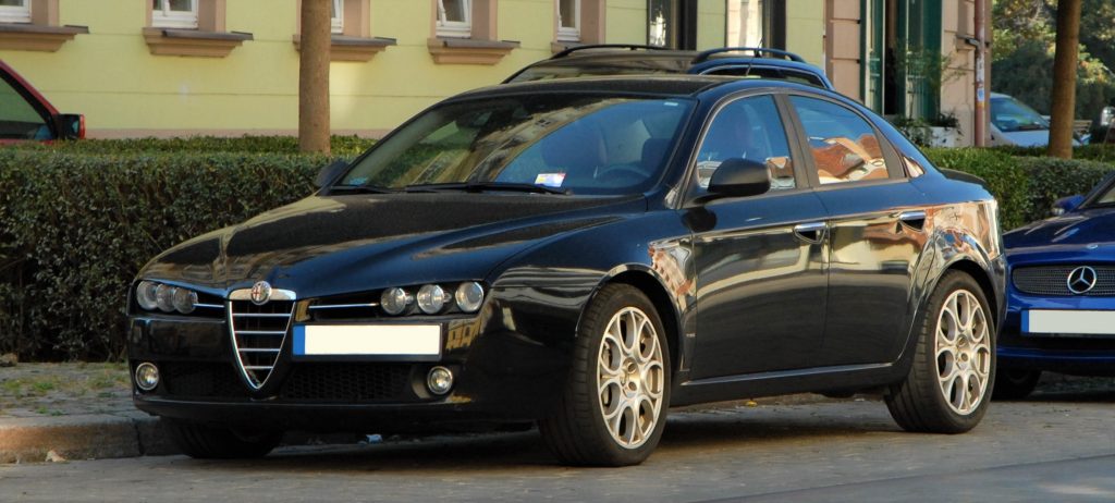 Used, black Alfa Romeo 159 on OEM alloy wheels.