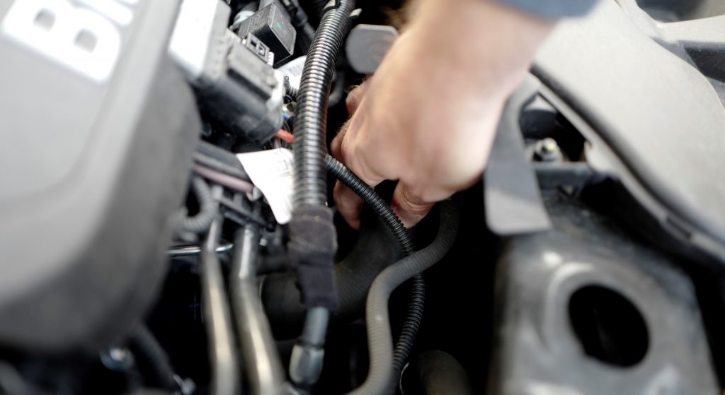 Squeezing the upper radiator hose can reveal head gasket problems in a used car.