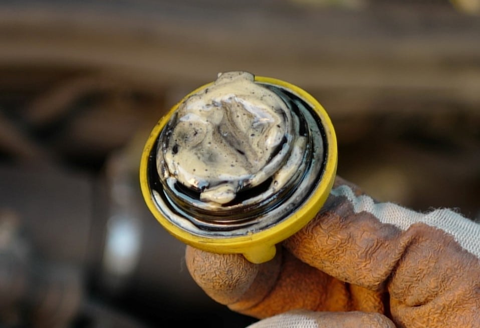 Milky substance that looks like mayonnaise under the engine oil fill cap. A typical sign of a head gasket leak.